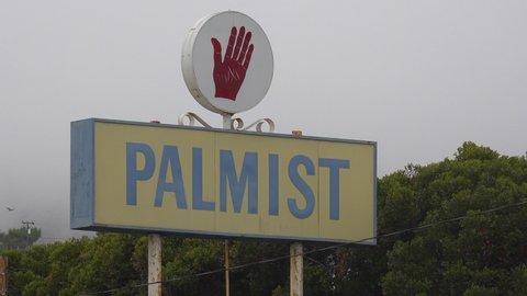 CALIFORNIA - CIRCA 2021 - Establishing shot of a palmist or mystic palm reading fortune teller.