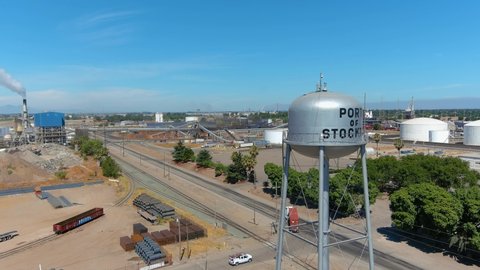 STOCKTON, CALIFORNIA - CIRCA 2021 - establishing aerial of Port Of Stockton industrial area with trucks and smokestacks.
