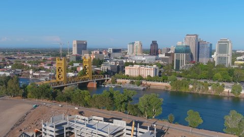 SACRAMENTO, CALIFORNIA - CIRCA 2021 - good aerial establishing shot of skyline downtown Sacramento, California with Sacramento River foreground.