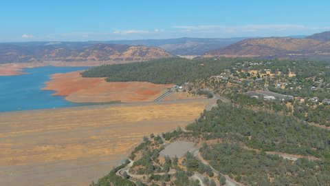 LAKE OROVILLE, CALIFORNIA - CIRCA 2021- High panning shot of Oroville Dam in California reveals extreme drought conditions.