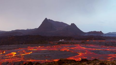 ICELAND - CIRCA 2021- Ground level shot of Iceland Fagradalsfjall volcano eruption with molten lava fields in motion foreground.