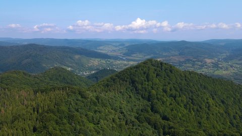 Сinematic aerial view of the endless mountains and forests of southern Slovenia. Drone flying through the forest
