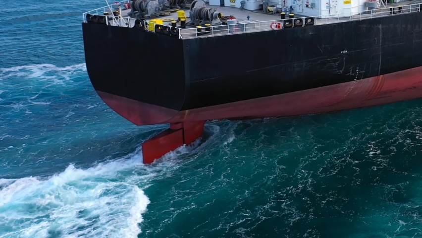 Close up of Large rudder of an oil tanker ship maneuvering into position a long distance off. Aerial following crude oil tanker from behind. Supertanker designed for chemical products transportation
 Royalty-Free Stock Footage #1078039868
