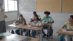 Male teacher speaking to multiethnic teenage students in class. High school - Powered by Shutterstock - Get 15% off with code: PIKWIZARD15