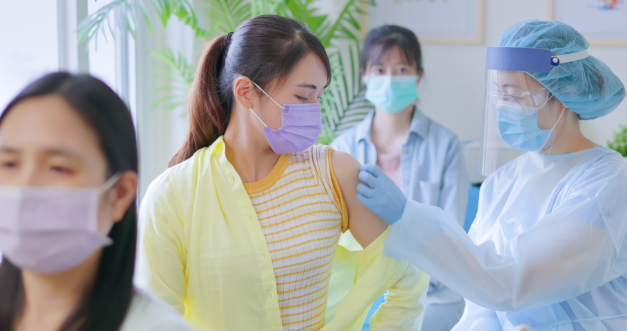 asian woman wearing face mask receiving coronavirus vaccine in hospital Royalty-Free Stock Footage #1078045421