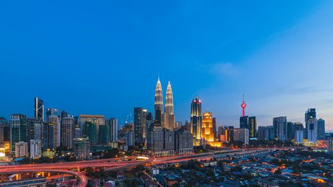 KUALA LUMPUR, MALAYSIA - MAY 28, 2016 : Time lapse: Kuala Lumpur city sunrise view overlooking the city skyline with busy expressway. 
