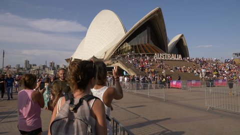 SYDNEY, NSW, AUSTRALIA. JANUARY 26 2020. Young woman takes photograph of Sydney Opera House on Australia Day, slow motion.