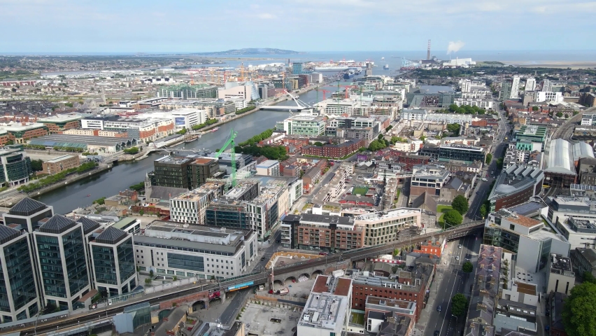 Aerial view over Dublin City Centre in Republic of Ireland. The drone is flying near the Dublin port on a bright sunny day. Royalty-Free Stock Footage #1078060403