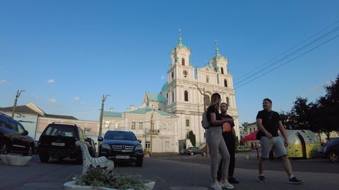 Grodno, Belarus - July 24, 2021: Timelapse of Soviet square in Grodno with famous Francis Xavier Cathedral, Farny the Jesuit Catholic Church on the background
