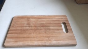 Baker puts freshly baked sourdough bread on wooden board. - Powered by Shutterstock - Get 15% off with code: PIKWIZARD15