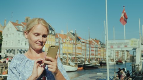 Portrait of a woman using a smartphone on a Copenhagen street in Denmark