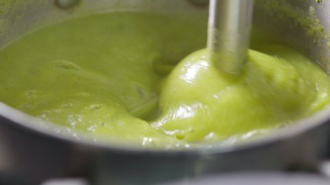 Preparation of broccoli puree soup with a blender. Vegetable cream soup