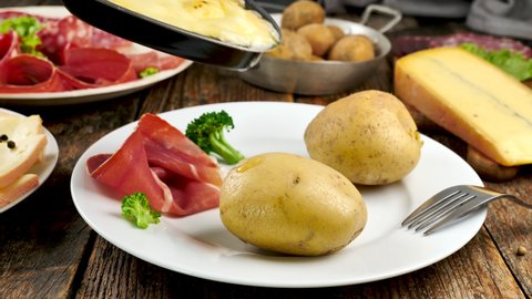 raclette cheese on potato and salami