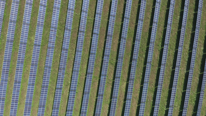 Bird's Eye View Of Solar Panels In The Green Field - drone orbit Royalty-Free Stock Footage #1078074506