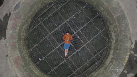 Aerial view of a person standing inside an abandoned Power Plant reactor in Charleroi, Belgium.