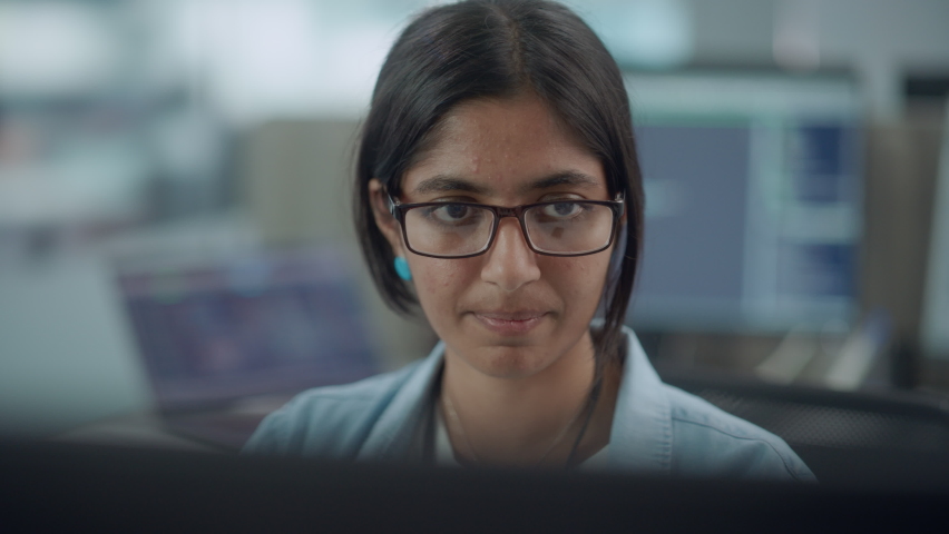 Diverse Office: Portrait of Confident Indian IT Programmer Working on Desktop Computer. Female Specialist Wearing Glasses Create Innovative Software. Professional Engineer Develop Inspirational App Royalty-Free Stock Footage #1078077644