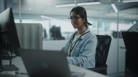Diverse Office: Portrait of Talented Indian Girl IT Programmer Working on Desktop Computer in Friendly Multi-Ethnic Environment. Female Software Engineer Wearing Glasses Develop Inspirational App