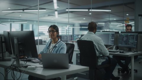 Diverse Office: Portrait of Confident Indian IT Programmer Working on Desktop Computer in Friendly Multi-Ethnic Environment. Female Software Engineer Wearing Glasses Develop Inspirational App