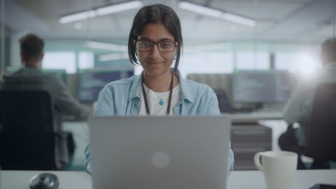 Diverse Office: Portrait of Smiling Indian IT Programmer Working on Desktop Computer. Female Specialist Create Innovative Software. Professional Engineer Develop App. Front View Zoom In