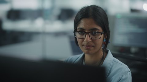 Diverse Office: Portrait of Empowered Indian IT Programmer Working on Desktop Computer. Female Specialist Wearing Glasses Create Innovative Software. Professional Engineer Develop Inspirational App