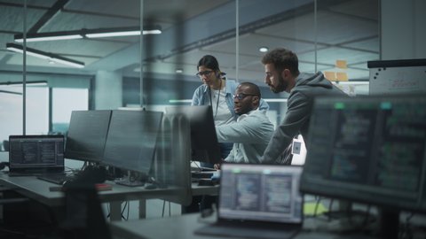 Diverse Multi-Ethnic Team Working in Modern Office: Group of IT Programmers Gather Around Desktop Computer, Talking, Finding Solution. Specialists Create Software. Engineers Develop App, Program
