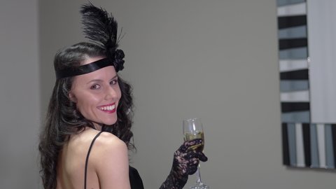 Portrait of a beautiful Gatsby woman, dressed in vintage Great Gatsby, roaring twenties fashion style drinking champagne and dancing on retro party
