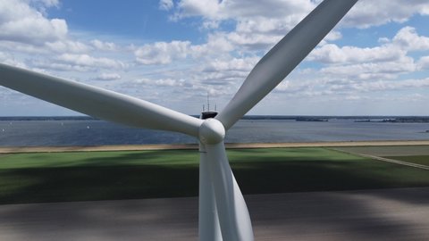 Aerial close up view of wind turbine a device that converts the wind's kinetic energy into electrical power providing a sustainable renewable source for homes and companies 4k high resolution