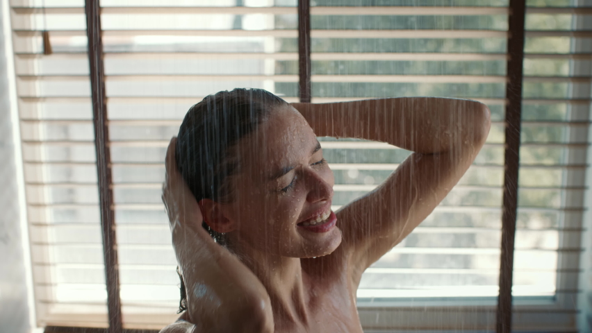 Bodycare. Happy Female Taking Refreshing Shower And Having Fun Singing And Dancing Enjoying Morning Beauty Routine Standing Under Falling Water In Modern Bathroom. Slow Motion | Shutterstock HD Video #1078083524