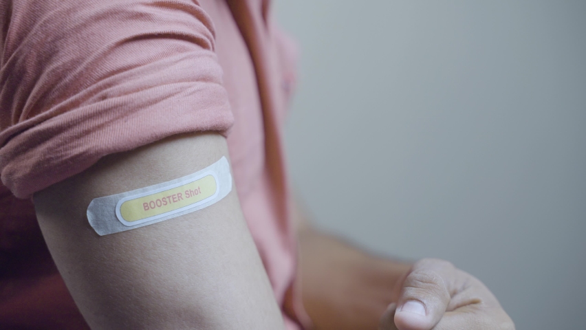 Covid-19 or coronavirus vaccinated shoulder with booster shot sticker and thumbs up gesture - concept of showing of approved coronavirus 3rd dose vaccination | Shutterstock HD Video #1078083956