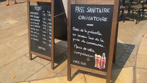 Aix-en-Provence, France - August 2021 : "health pass required" written in French at the entrance of a terrace Restaurant during the Covid-19 pandemic in Aix en Provence, France