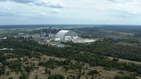Aerial view of Chernobyl Nuclear power plant. Reactor 4 covered with the new safe confinement arch named sarcophagus. Pripyat ghost town at Chernobyl Exclusion Zone, Ukraine