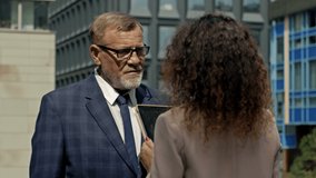 Business team man and woman working together outside. Boss and assistant holding tablet taking notes. Boss and secretary having consultation outdoor. - Powered by Shutterstock - Get 15% off with code: PIKWIZARD15