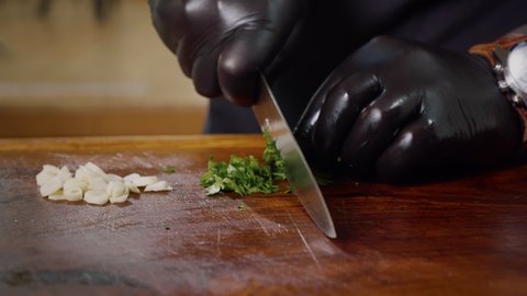 Chopping Fresh Green Parsley on a Wooden Chopping Board. Food Industry. Close up Slow Motion.