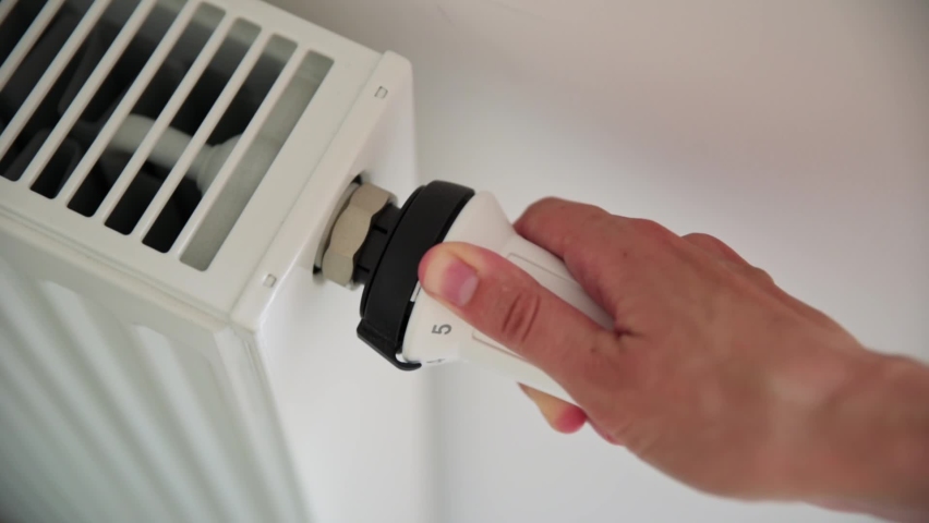 Heat radiator knob. Woman hand adjusting temperature on heating radiator Royalty-Free Stock Footage #1078091687