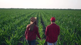 Agriculture. Happy family of farmer. Agricultural business. Farmer are walking in the corn field. Farmer on fertile soil. Agriculture and agricultural business concept. Farmers in corn on fertile soil
