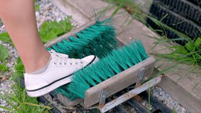 A girl cleans shoes on the street with a special brush close up 4k video