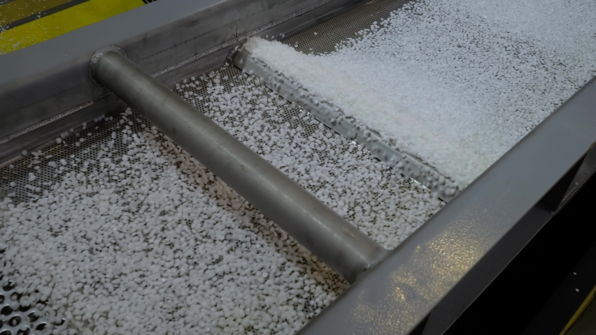 Propylene or polyethylene pellets - recycled plastic granules on conveyor belt, shale shaker of waste plastic recycling machine. Environmental protection, automated technology, separation concept | Shutterstock HD Video #1078096949