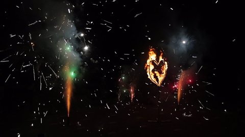 Fiery heart. A fiery burning heart in the dark. Burning heart of love. Fire show the wedding. Realistic Fire - Slow Motion.