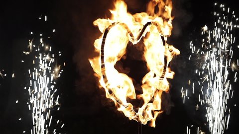 Fiery heart. A fiery burning heart in the dark. Burning heart of love. Fire show the wedding. Realistic Fire - Slow Motion.