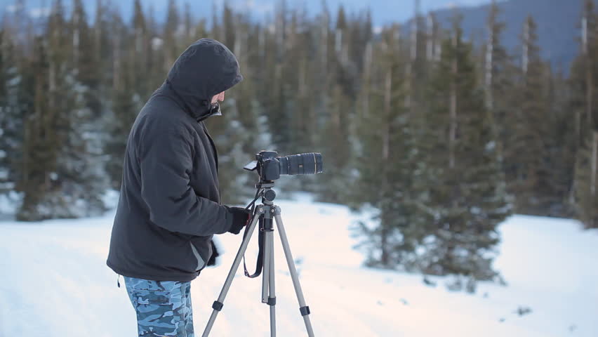 Nature Photographer at winter mountain