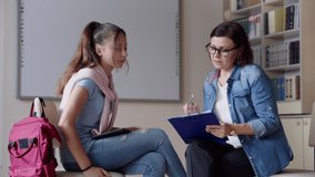 Woman school psychologist teacher talking and helping student, girl teenager - Powered by Shutterstock - Get 15% off with code: PIKWIZARD15