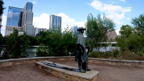 Austin , Tx , United States - 08 20 2021: Stevie Ray Vaughan Statue, City of Austin Skyline, and Butler Park