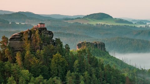 Breakfast or morning picnic of tourists group on popular lookout tower Mariina vyhlidka. The significant viewpoint in Bohemian Switzerland National Park, Czech Republic. Slow motion or timelapse.