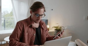 Caucasian male studying from home using digital tablet 