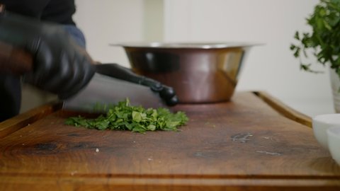Close up Chopping Fresh Green Parsley on a Wooden Chopping Board.