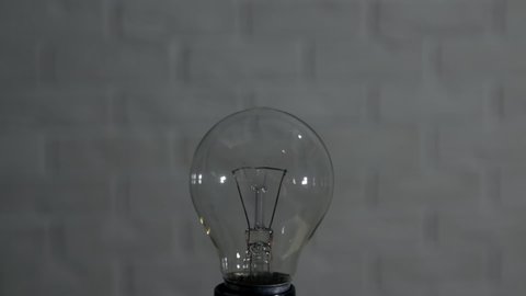 Replace old bulb for new one. The concept of developing new effective technologies to replace obsolete ones. LED energy saving lamp and incandescent lamp.