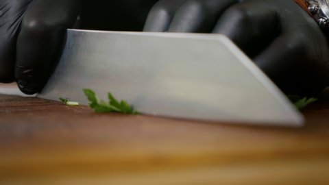 Close up Chopping Fresh Green Parsley on a Wooden Chopping Board.