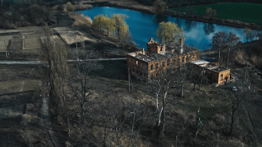 
abandoned house by the lake in autumn