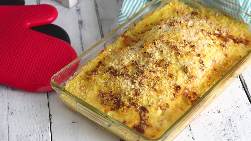 baked salmon with diced corn and carrots in garlic cream sauce and cheese