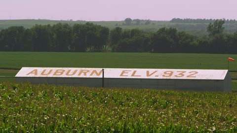 Static shot of corn field and building showing the elevation in Auburn Nebraska.